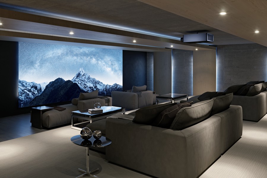 A home theater with an image of snow-covered mountains on a projector screen.